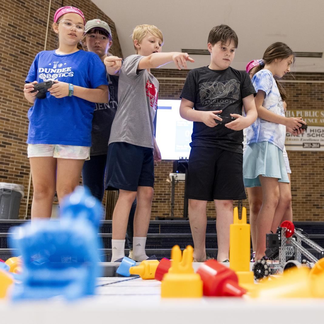  A group of students work on a task at robotics camp